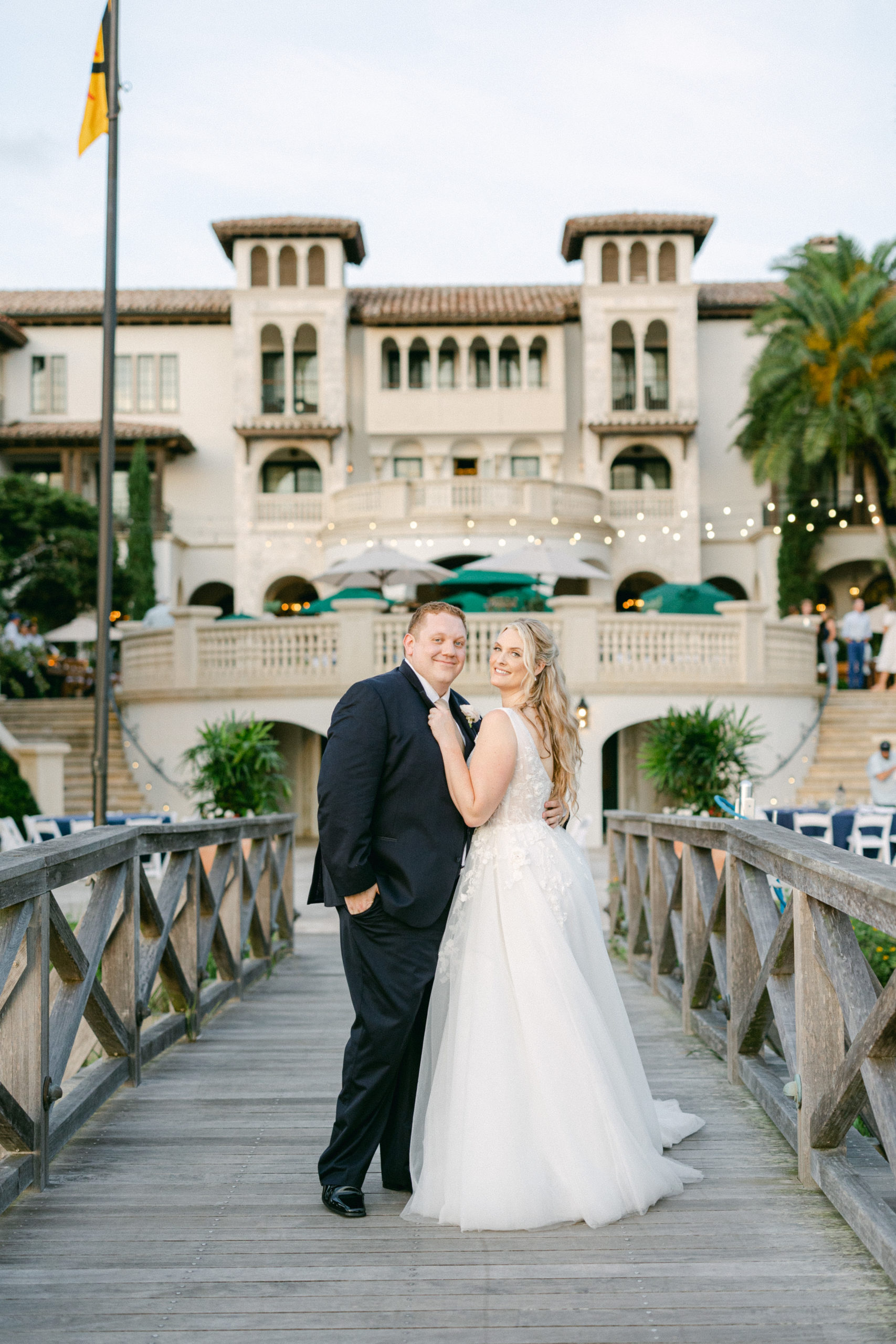 bride and groom standing on the bridge right outside of the cloister at sea island